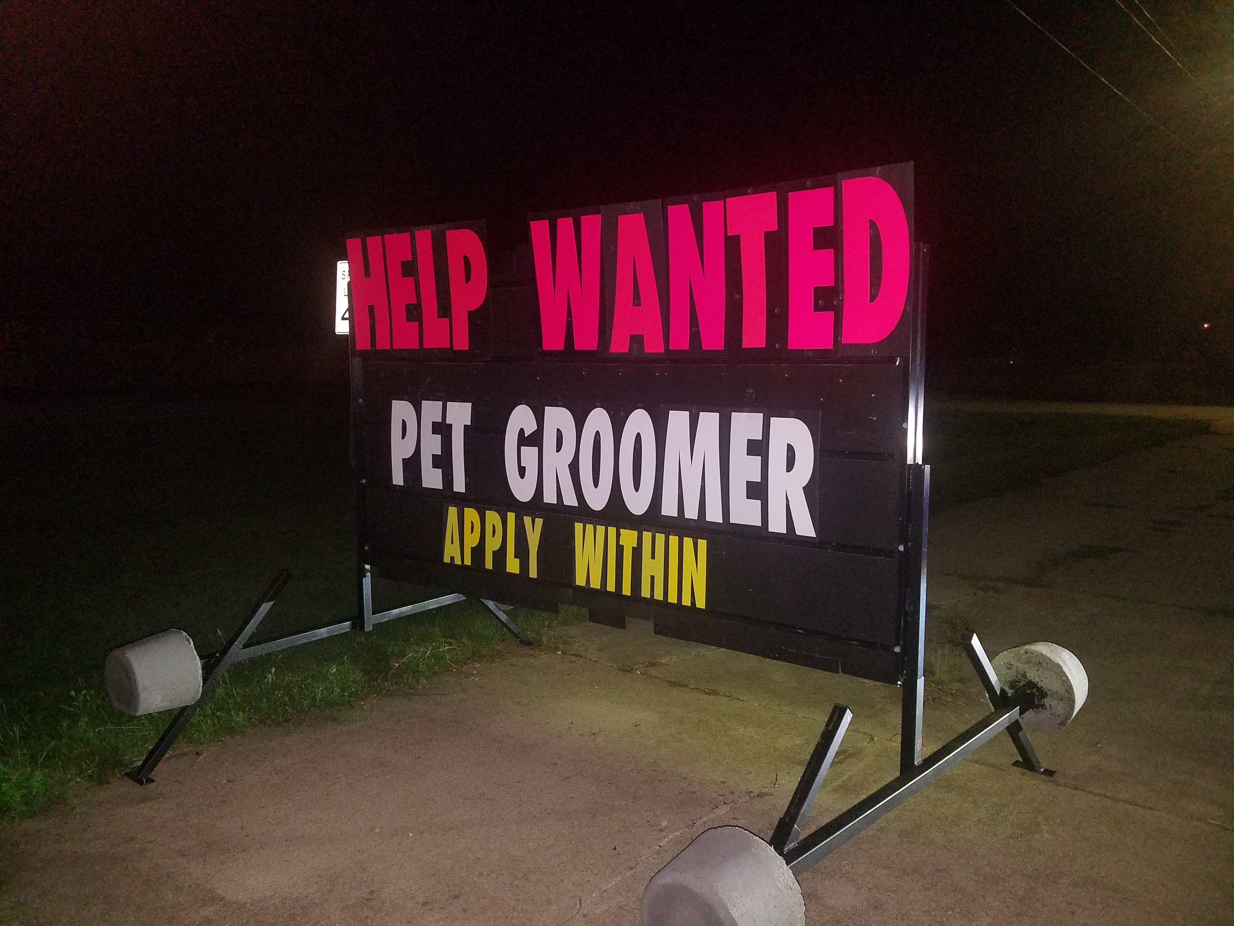 Help wanted sign advertising a pet groomer position