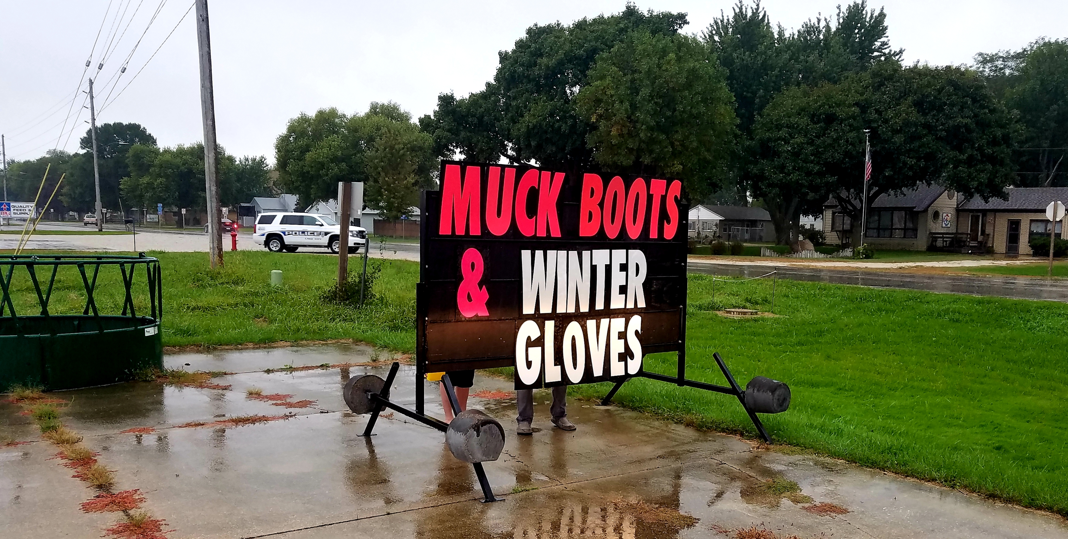 Portable sign promoting Muck boots and winter gloves