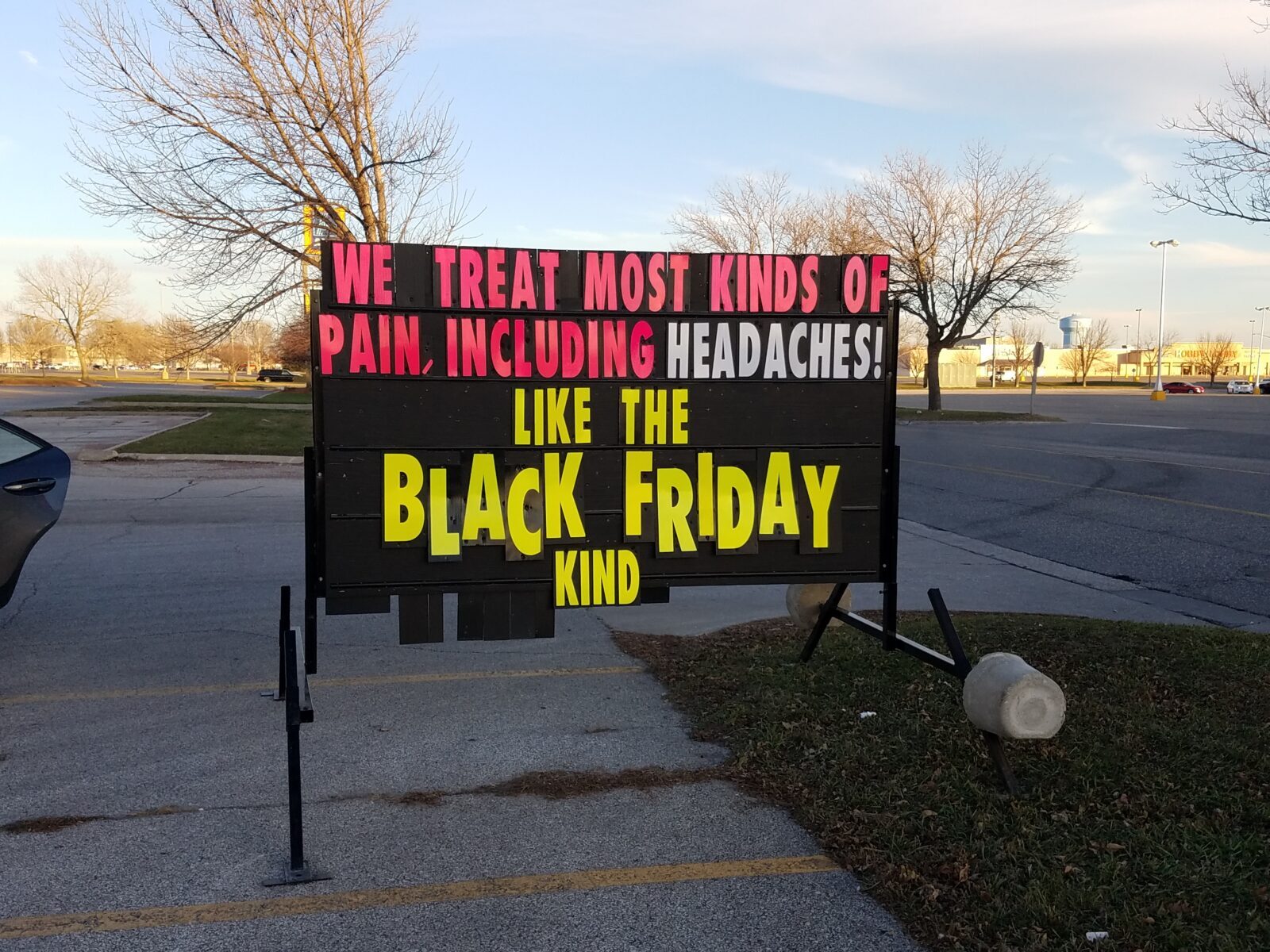 Portable sign promoting a local pain treatment service